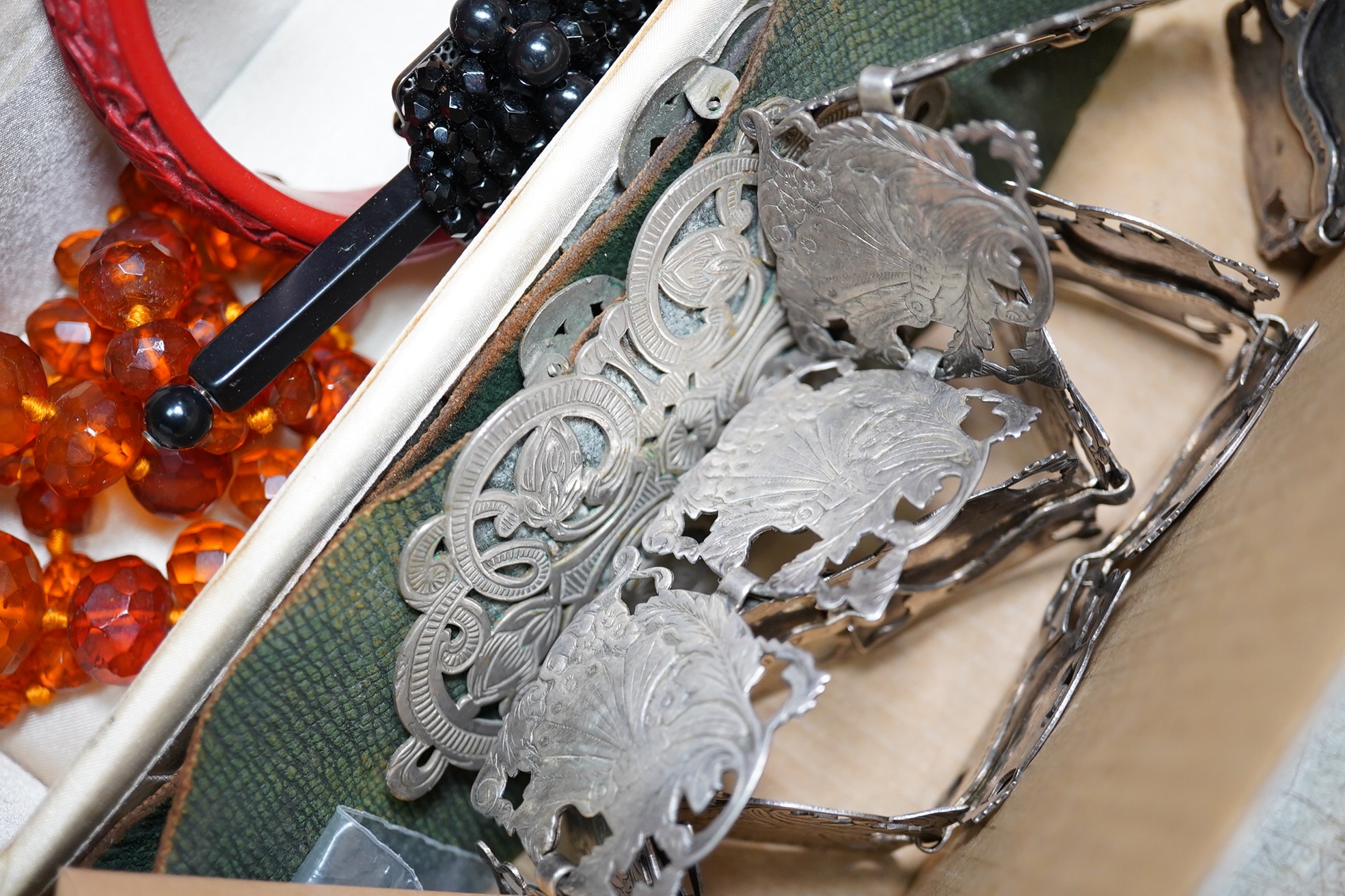 A silver plated ornate lady's belt, various items of costume jewellery, two beaded evening bags and a black jet mounted bag. Condition - varies